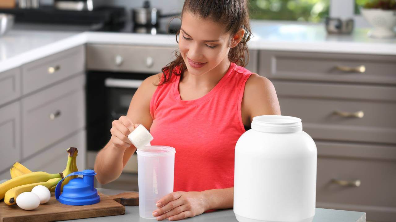 A woman adding unflavored collagen powder to her protein shake, one of many ways to use collagen supplements.